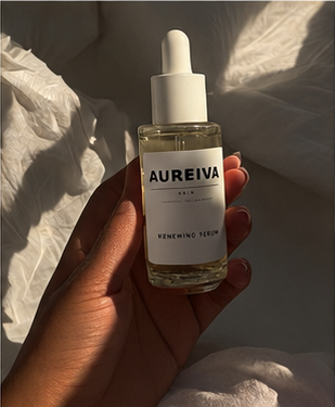 Aureiva serum held in warm natural light